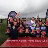 Pupils from Ballymoney High School & Our Lady of Lourdes School mark the “Show Racism the Red Card” campaign as part of the “Different Ball, Same Goal” project. Also included is Jonny McFadden, Sports Development Manager with CCGBC.