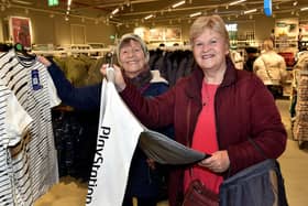 Sisters Yvonne Bryce, left, and Jean Harris searching for Christmas gifts at the new Primark store. PT50-224.