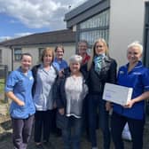 (L to R) Community Staff Nurse, Kelly Fitzsimons, Senior Health Care Assistant, Susan Jones, Community Staff Nurse, Elaine Cleland, District Nurse, Lee-Anne Dick and Senior Community Staff Nurse, Jenny White (far right). At the Front (L to R) Robert Quigg’s wife, Andrea and sister, Liz.