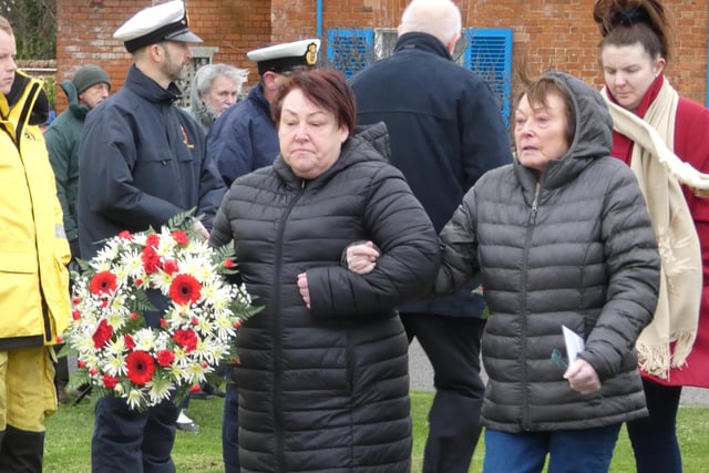 Members of the Ogilby family preparing to lay their wreath at the memorial.