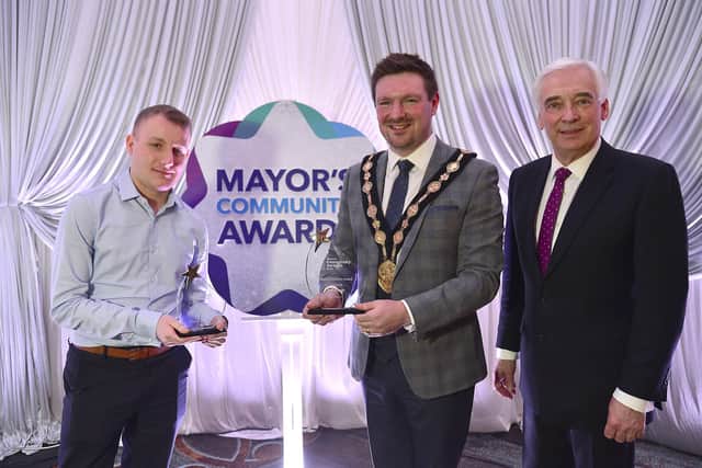 Ben Annett from Brooklands Youth Centre is pictured with his two Awards: the Brian McDowell Volunteer of the Year Award and the Mayor's Choice Award presented by Mayor, Councillor Scott Carson and Paul Clark.