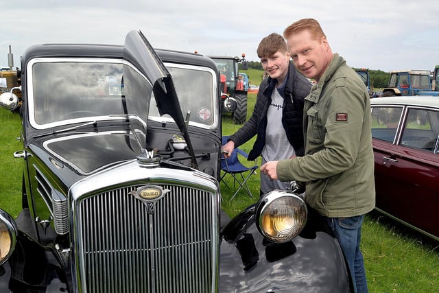 Checking out the engine of a vintage Wolseley car at the annual  Birches Vintage Rally are Charlie McElmurray and dad, Alan. PT27-208. Photo by Tony Hendron