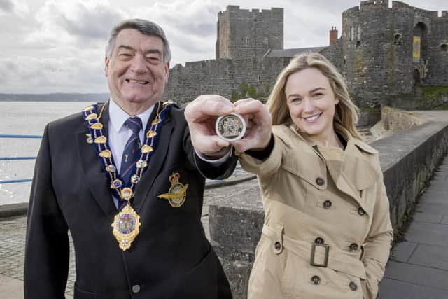 The Mayor, Alderman Noel Williams and  Councillor Cheryl Brownlee holding a coin similar to those which will be distributed.