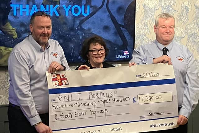 Lifeboat Operations Manager Beni McAllister (left) receiving a cheque for £17,370 from Alice Rohdich and Dr Martin O'Kane. Credit Una Culkin