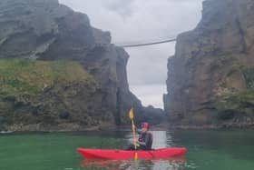 Presenter Sara O’Kane kayaking at Carrick-a-Rede rope bridge. Credit: UTV