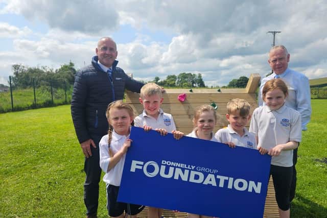 Paul McKulkin, Site Director at Donnelly Group Enniskillen and Malcolm Kerr, Finance Director at Donnelly Group with students from Tattygar Primary Schoo