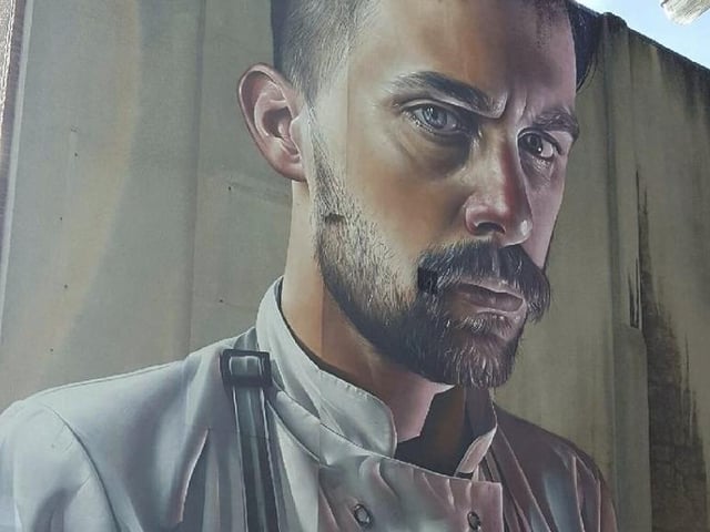 Hailing from Australia originally, Smug’s life-like designs stand out from the crowd, often immortalising his friends in giant portraits.

The strikingly realistic image of a man with a lobster titled The Chef is on show to all right at the bottom of the high street, standing at three storeys tall.