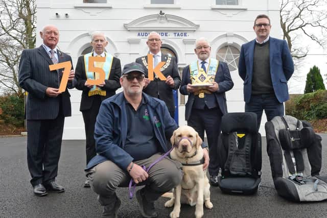 Mervyn Bryans, NI representative from Prostate Cancer UK is pictured with Freemasons, Mal Ross, Leslie Nixon and Barry Brewster with Gareth Johnston from IN Car Safety NI and Gary Jordan and dog Lexi from Assistance Dogs NI