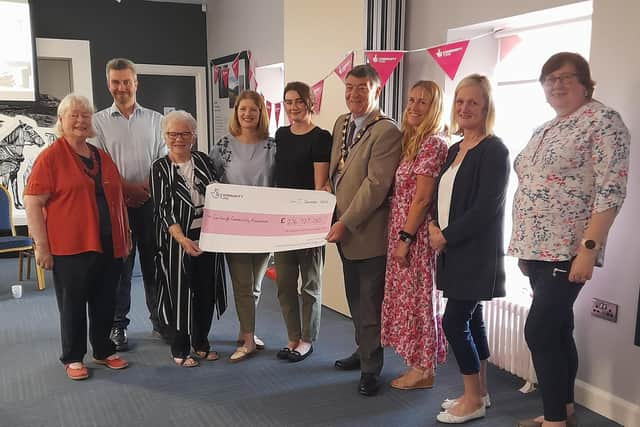 Pictured, left to right, at the Carnlough Community Association funding presentation are:  Mary Watson, Secretary; Danny Donnelly MLA; Patricia McConnell, chairperson; Claire Mulholland, principal, Carnlough Controlled Integrated Primary School; Amy O’Neill, administrator,  the outgoing Mayor of Mid and East Antrim, Noel Williams; Gillian Irvine, funding manager, National Lottery Community Fund; Joanne McIlhatton, programme co-ordinator and Councillor Maureen Morrow.