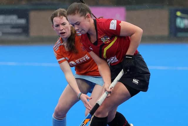 ​Gina Woods expertly shields the ball against her Ards opponent.