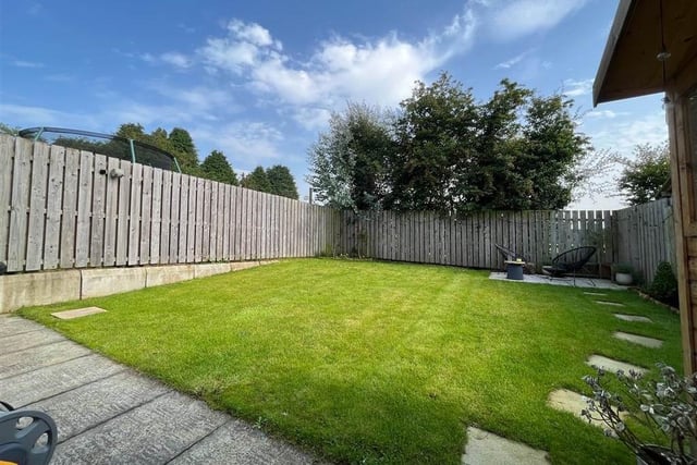 Landscaped rear garden with paved patio area.