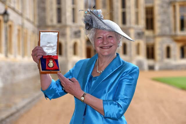 WINDSOR, ENGLAND - MAY 19: Dame Mary Peters holds her insignia of member of the Order of the Companions of Honour services to Sport and to the community in Northern Ireland at an investiture ceremony at Windsor Castle May 19, 2015 in Windsor, England. (Photo by Andrew Matthews - WPA Pool/Getty Images)