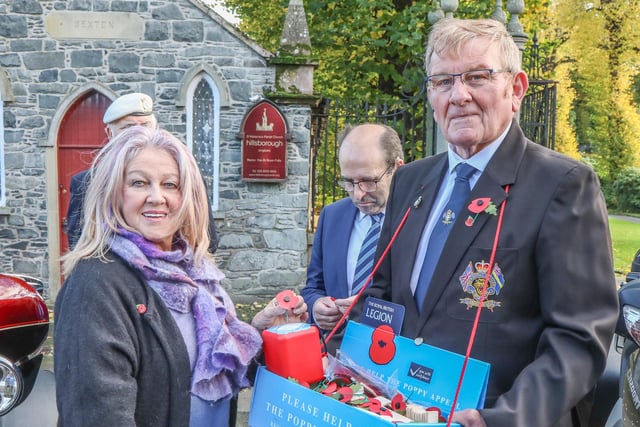 Dawn McEntee Chair of Royal Hillsborough Village Committee buying one of the first Poppies from Mervyn McAleese Poppy Appeal Organiser. Pic by Norman Briggs, rnbphtgraphyni