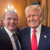Communities minister Gordon Lyons with US President Donald Trump