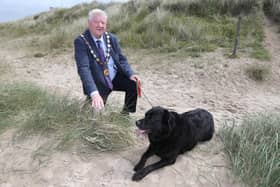 The Mayor of Causeway Coast and Glens, Cllr Steven Callaghan, with his dog Buster, reminding beach users to be aware of summer time dog control restrictions. Credit Causeway Coast and Glens Council