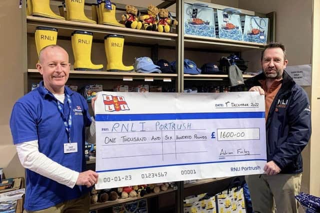 Adrian Finlay presenting Trevor Abernethy from the RNLI with a cheque for £1600