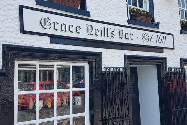 Built in 1611, Grace Neills is the oldest bar in Northern Ireland. Formerly known as The Kings Arms, the pub was passed down to Grace by her father.
In no time at all Grace established herself as a staple of the pub, with a friendly yet firm demeanour she was quick to check the manner of her regulars.
After passing away in 1916, the pub was renamed to Grace Neills in her memory. For over a century now, many have felt a welcoming and hospitable presence from time to time; with theories suggesting it may be Grace herself keeping a watchful eye over her beloved pub. Some have even said to have spotted a woman in a Victorian dress in front of the bar.
As time went on, staff and regulars have witnessed sweeping noises, moving glasses by unseen hands and cups falling from shelves.
However, while this friendly presence resides downstairs, something darker lurks above.
Staff have claimed to have seen a shadowy figure several times while also hearing heavy footsteps coming from upstairs when no one is there; ghost hunter Mike Hirons felt he encountered an evil presence during an investigation of the area.
Despite more modern extensions being added onto the building, the original pub still stands in its traditional glory, and, regardless of the spirits who may reside there, current clientele is more appreciative of the other spirits available.
For more information, go to graceneills.com