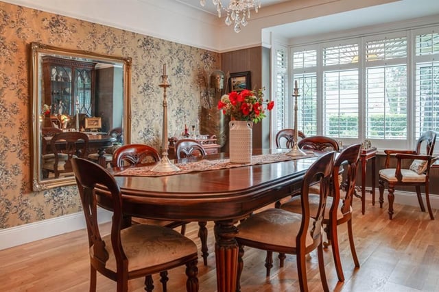 Dining room with ceiling cornice, picture rail, and solid wood flooring.