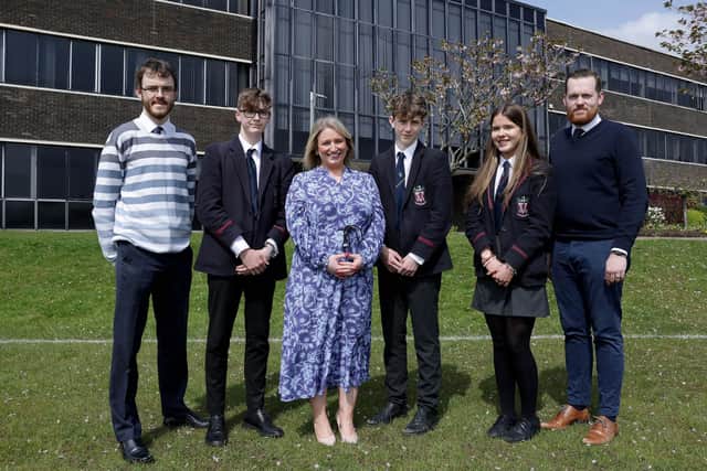 Teachers Mr McGeown and Mr English with students Jason Murphy, Rory Cauley, and Katie Longley with Catriona McGirr, Community Engagement Manager, Bank of Ireland.