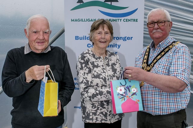Mayor, Cllr Oliver McMullan presents gifts on behalf of the Community Allotment members to Eddie Mellon and Annie Mary Mullan for their work and commitment to the scheme.