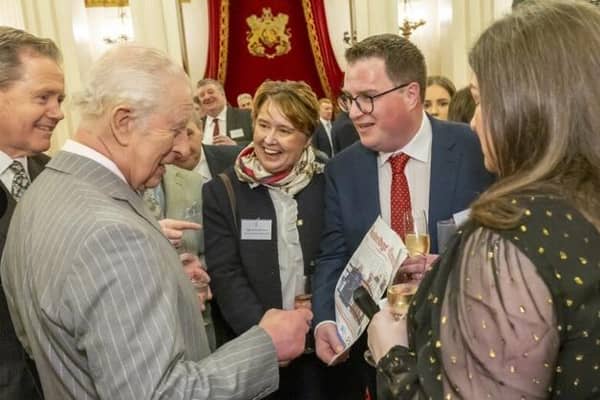 Hitting the headlines at the palace! Chronicle editor Michael Scott shows this week's front page to King Charles. Photo credit: Ian Jones.