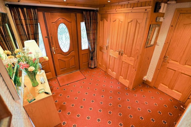 The entrance hall has a wood panel and glazed front door with wood panel and glazed side panelling; two cloakrooms and hot press.