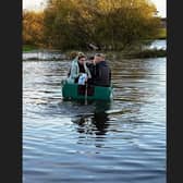 Katie Girvan from Hamill's Pharmacy in Portadown hitched a lift with boatman Barry McCann to deliver urgent medication to an elderly customer during floods in the Co Armagh town yesterday.