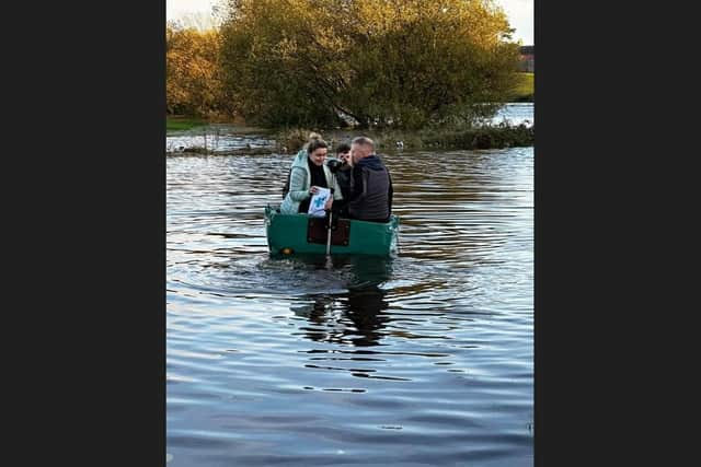 Katie Girvan from Hamill's Pharmacy in Portadown hitched a lift with boatman Barry McCann to deliver urgent medication to an elderly customer during floods in the Co Armagh town yesterday.