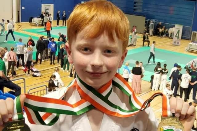 Fiachra Duggan proudly showing his two gold medals. Credit: Contributed