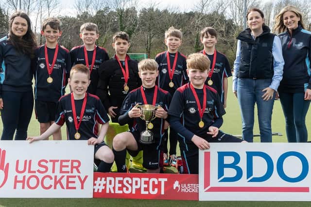 Winners of the Ulster Hockey’s Youth Division Pearson Cup, Pond Park Primary School, Lisburn pictured with their teachers (far left and far right) and Laura Jackson, Partner at BDO Northern Ireland, sponsors of the competition. Image credit: The Front Row Union Sports.