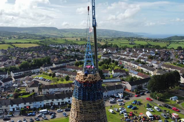 The moment the top was added to the huge bonfire at the Larne estate. Photo by: AmandaAnne McWhinney, AWP, Bangor.