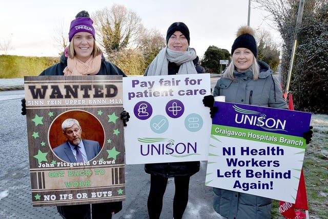 Wrapped up well against the cold are Unison members who joined the strike at Craigavon Area Hospital. PT03-248.
