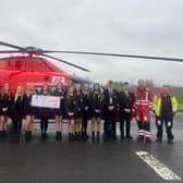 Staff and students from Limavady High School pictured with members of the Air Ambulance NI HEMS crew at their base.