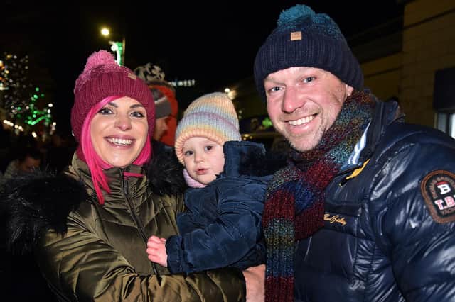 All smiles at the Christmas lights switch on are the Potts family from left, mum Alex, Penelope (2) and dad, Robert. PT47-200.