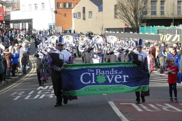The Clover Band passes along High Street.