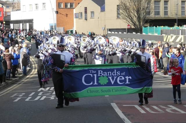 The Clover Band passes along High Street.