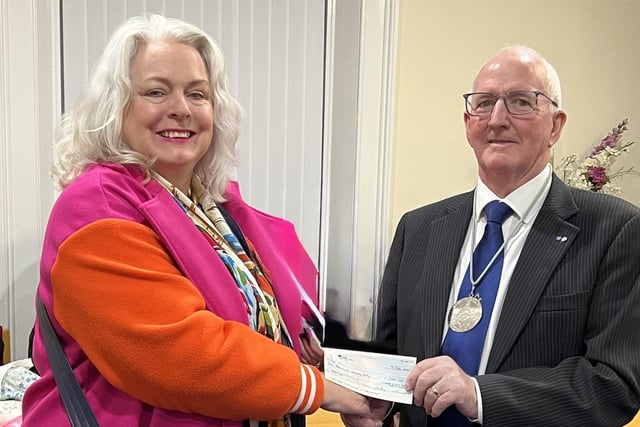 Chairman of the Lisburn and District Masonic Charity Fund, Eddie Carson presented a cheque to a representatives from Age NI