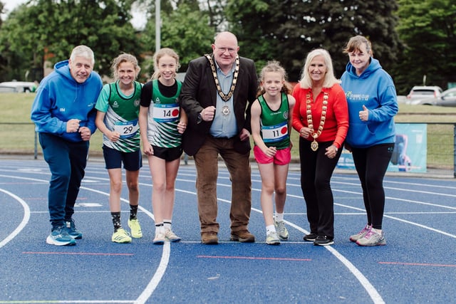 Mayor of Antrim and Newtownabbey, Councillor Neil Kelly and President of the Athletics NI Board, Wendy Philips joins representatives from PACE Running Club and Ballymena and Antrim Athletic Club to celebrate the newly resurfaced track.