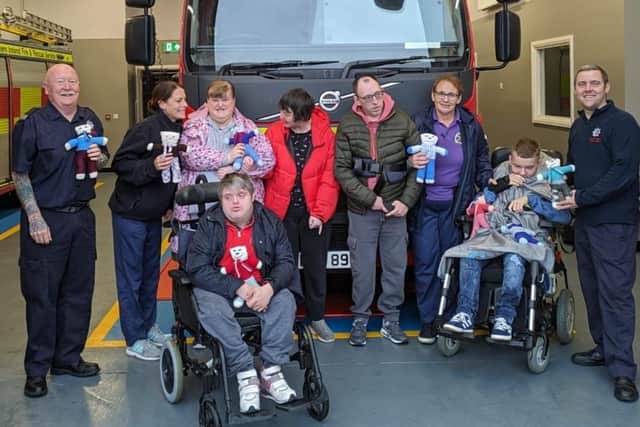 Visitors from Larne Adult Centre deliver some of the teddies with Michelle and Warren Logan.  Photo: Carrickfergus Fire Station