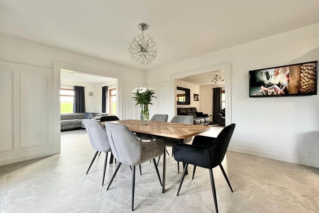 The dining area is fitted with feature wall panelling, eye level TV point, double doors leading out to the rear garden and is open plan through to both the sitting room and family room.
