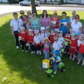 Hundreds of people have signed a petition against the closure of Hansel & Gretel Pre-school, which has been serving the community in Glynn for over 30 years.  Here, staff and children are pictured during the 'Teddy Toddle' in 2009.  Photo: P Rippon