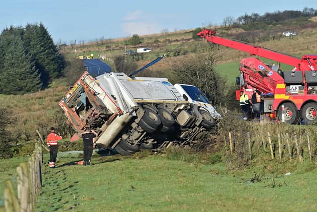 A bin lorry is recovered after it overturned on the Tornagrough Road in the Hannahstown area during the freezing conditions on Monday morning. Picture: Colm Lenaghan / Pacemaker