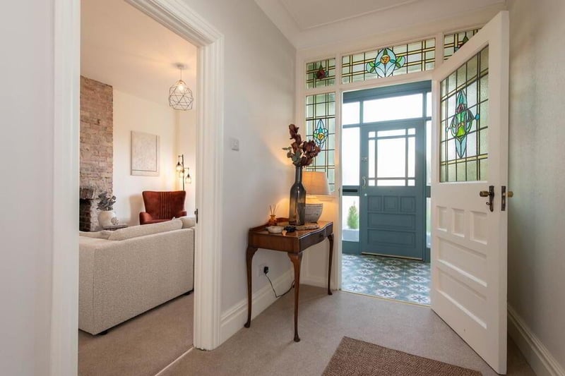 Reception hall featuring original door with stained leaded glass.