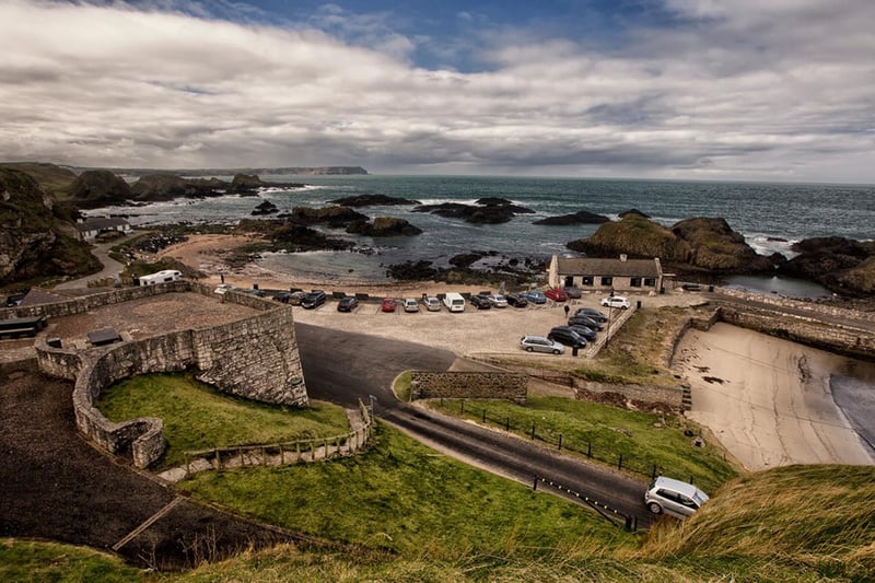 Ballintoy Harbour is the Game of Thrones filming location for Lordsport, the main port of Pyke. One of the Iron Islands, Pyke is the home of Theon and Yara Greyjoy. 
Located on the North Coast, with its panoramic coastal views, rocky landscape and bustling wildlife, Ballintoy Harbour is the perfect backdrop for Pyke. 
In season two of Game Of Thrones, it is here that we see Theon returning home after his time as a ward in Winterfell. We are first introduced to Theon’s sister Yara, who watches him get baptised. 
Be sure to check out The Fullerton Arms closeby to the harbour, where one of the ten hidden doors can be found commemorating Game Of Thrones. The ‘sixth’ door features the fearsome dragon Drogon with Dothraki stallions, symbolising the Dothraki allegiance with Queen Daenerys.