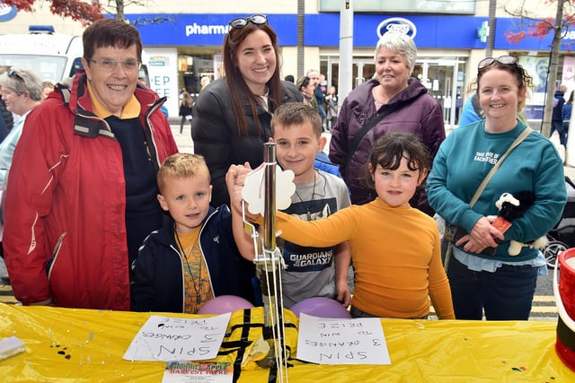 Catherine Dixon, left, Portadown Rotary Club Past President, encourages members of the crowd at Country Comes To Town during the club's fundraising 'Human Fruit Machine' game. PT41-202.