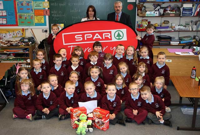 Largymore Primary School Pupils Ann Ferris and Jade Mullan pictured with their easter eggs which they won in the Saintfiled Road Spar Easter Colouring in Competition in 2009 Also pictured are their class which also entered the competition
