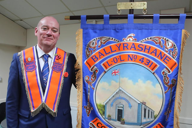 Wor. Bro. David Keers W.M. proudly displaying the beautiful bannerette which depicts the War Memorial Orange Hall which will be celebrating 100 years in 2026. Ballyrashane War Memorial Orange Hall has been under extensive restoration works for four years