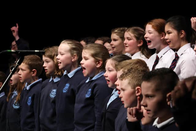 Some of 450 pupils from 19 primary, secondary and secondary schools singing the hymn.