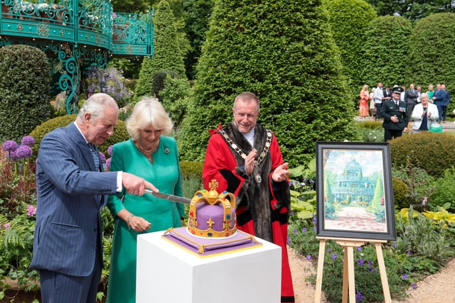 King Charles and Queen Camilla cut a specially created cake at the official opening of the coronation garden in Hazelbank Park. Picture: Kelvin Boyes / Press Eye