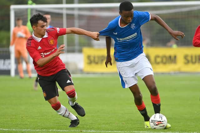 Rangers Paul Nsio  in action with Manchester United’s  Zach Giggs